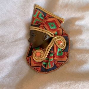African lady brooch in kente cloth.